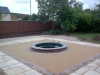 Bonded aggregate paving around a fountain